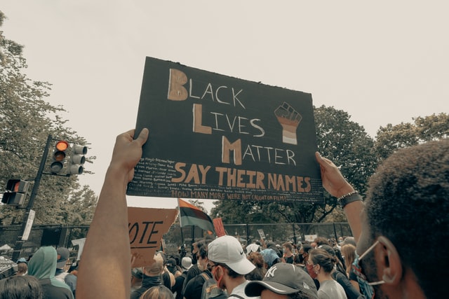 "Black Lives Matter, Say Their Names": Man holding up a sign at a Black Lives Matter protest